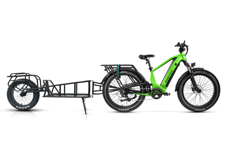 Green Magicycle Deer e-bike with cargo trailer designed for outdoor exploration.