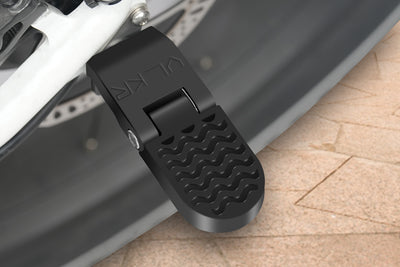 Collapsible black footrest peg for rear passengers on electric bikes.
