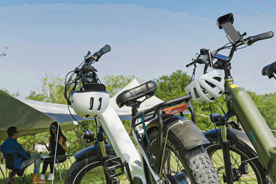 Bike phone mount holder attached to handlebars with cyclists in the background.