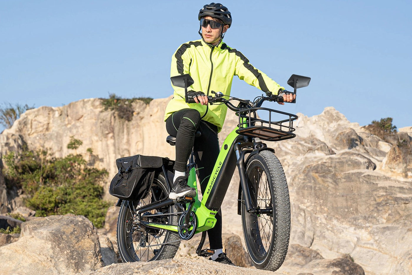 Cyclist in neon jacket riding Magicycle fat tire ebike on rocky terrain