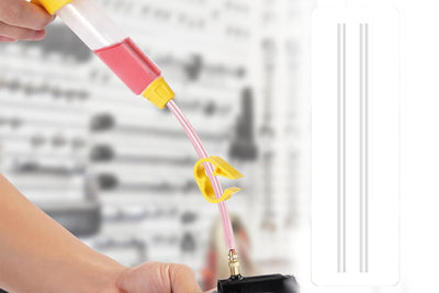 Syringe from a brake bleed kit with yellow funnel for hydraulic brake maintenance