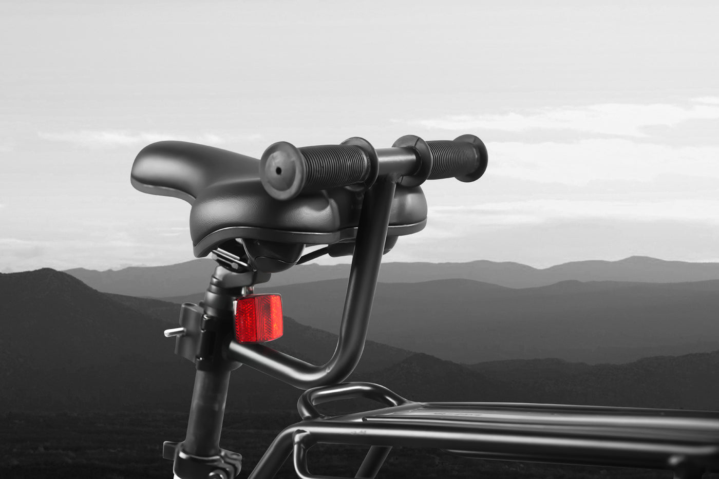 Rear view of Ebike armrest handlebar with textured grips, overlooking mountains.