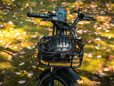 Bicycle front basket with black helmet and cargo net on autumn leaves