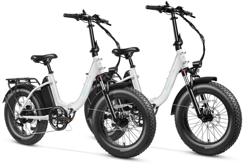 White and navy blue Magicycle Jaguarundi 2.0 fat tire ebikes for outdoor adventures.