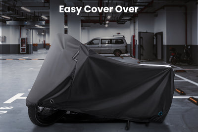Black waterproof cover on folding electric bike in garage with easy cover over text.