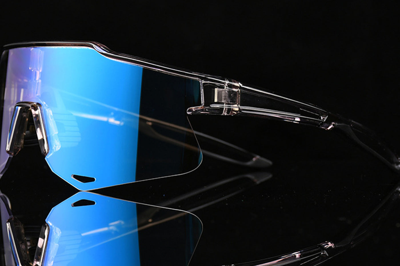 Clear cycling sunglasses with blue photochromic lenses and adjustable frame.
