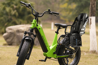 Green Magicycle electric bike with rear-mounted child carrier seat and safety features.