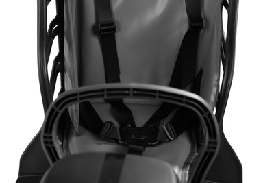 Interior view of rear-mounted child seat with safety straps and padded comfort.
