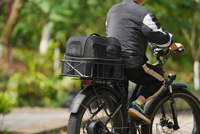 Ebike rider with large black iron rear rack basket for versatile cargo storage.