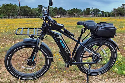 Magicycle electric bike with front rack and black battery in a scenic outdoor area