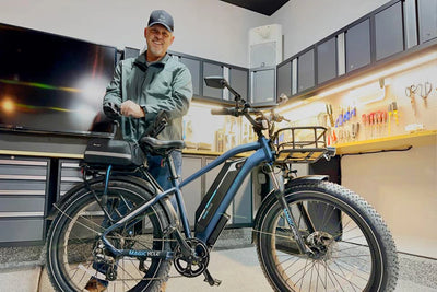 Person with Magicycle electric bike in a garage, highlighting its design and storage.